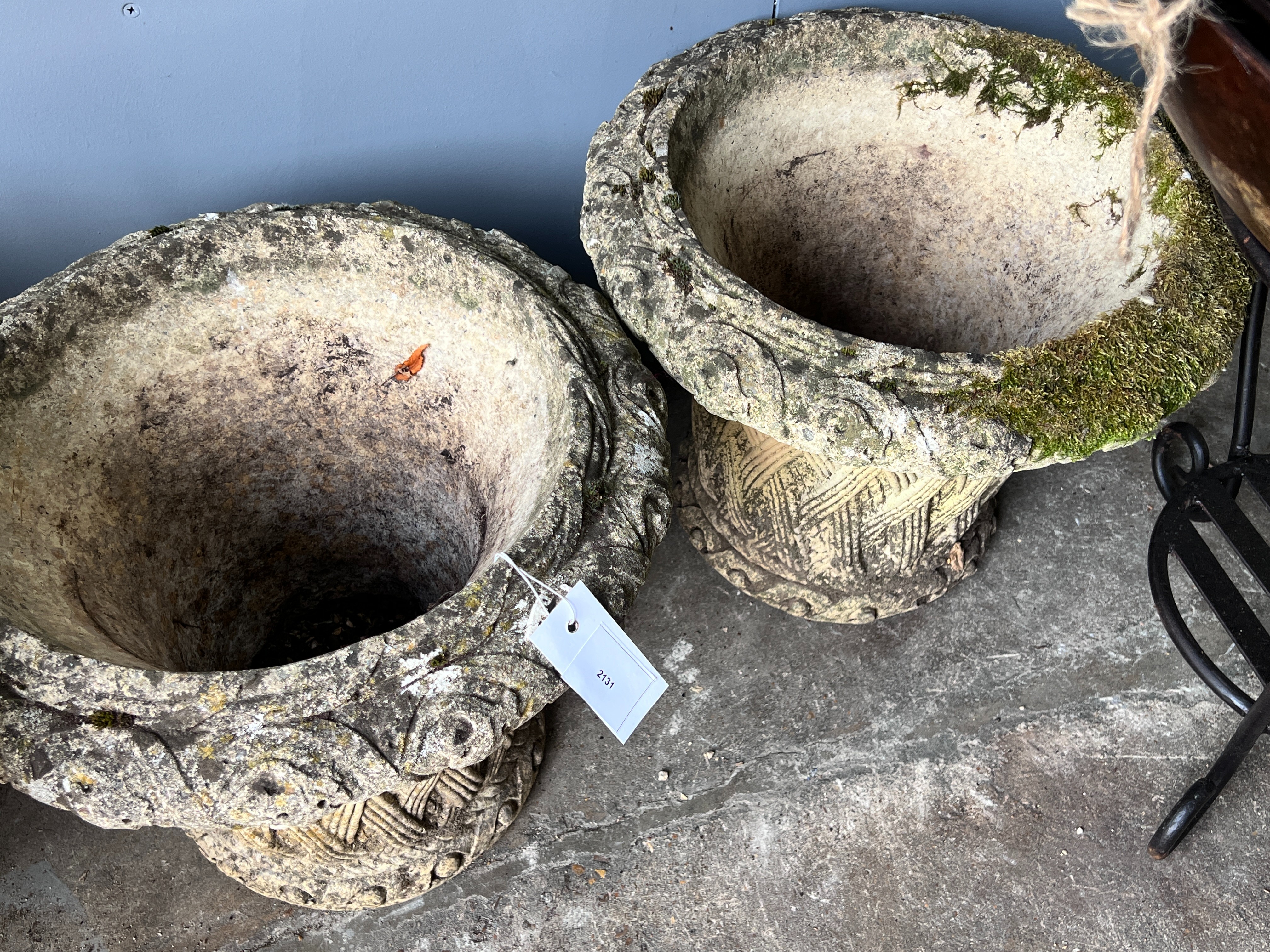 A pair of circular reconstituted stone basket weave effect garden planters, diameter 38cm, height 32cm